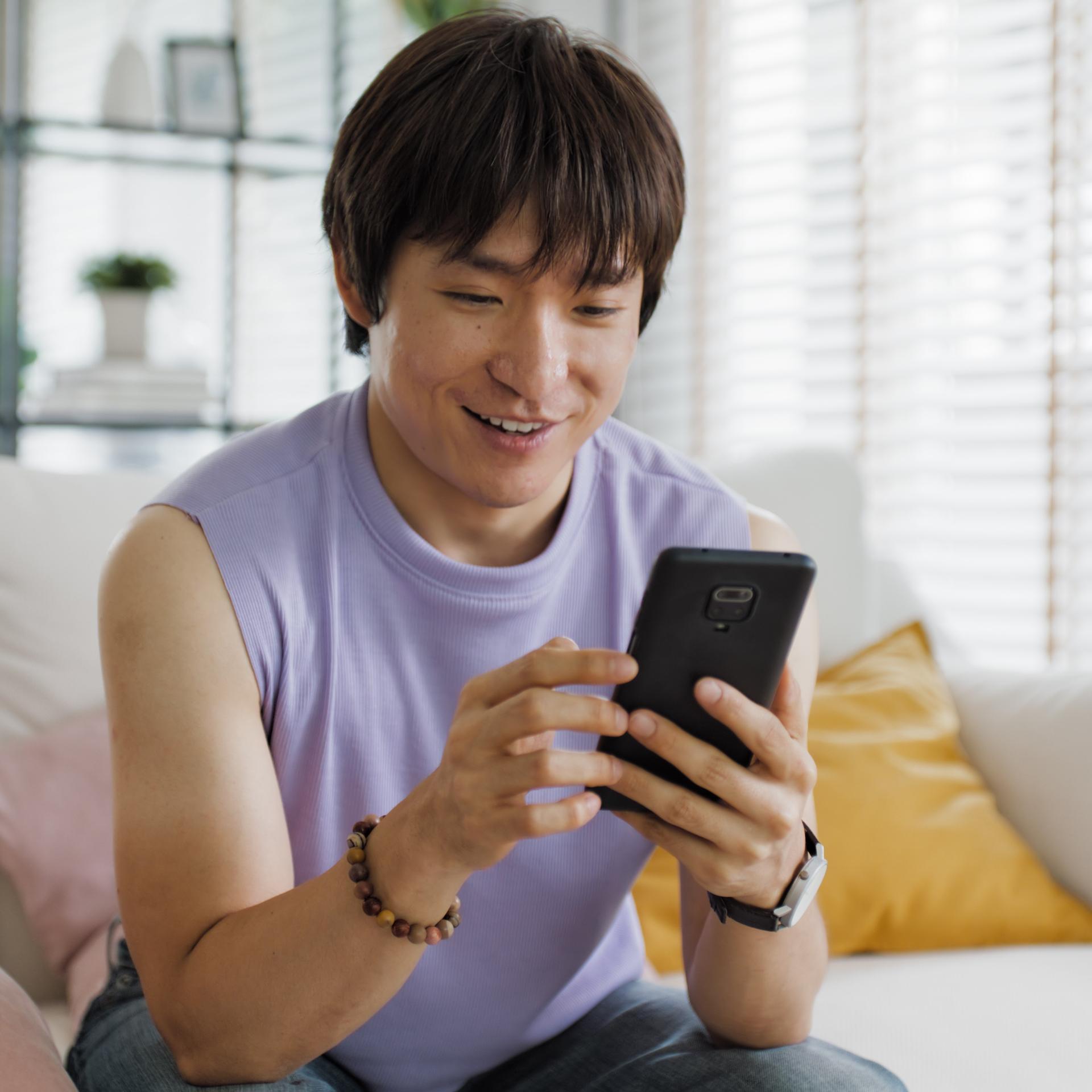 Asian man looking at phone