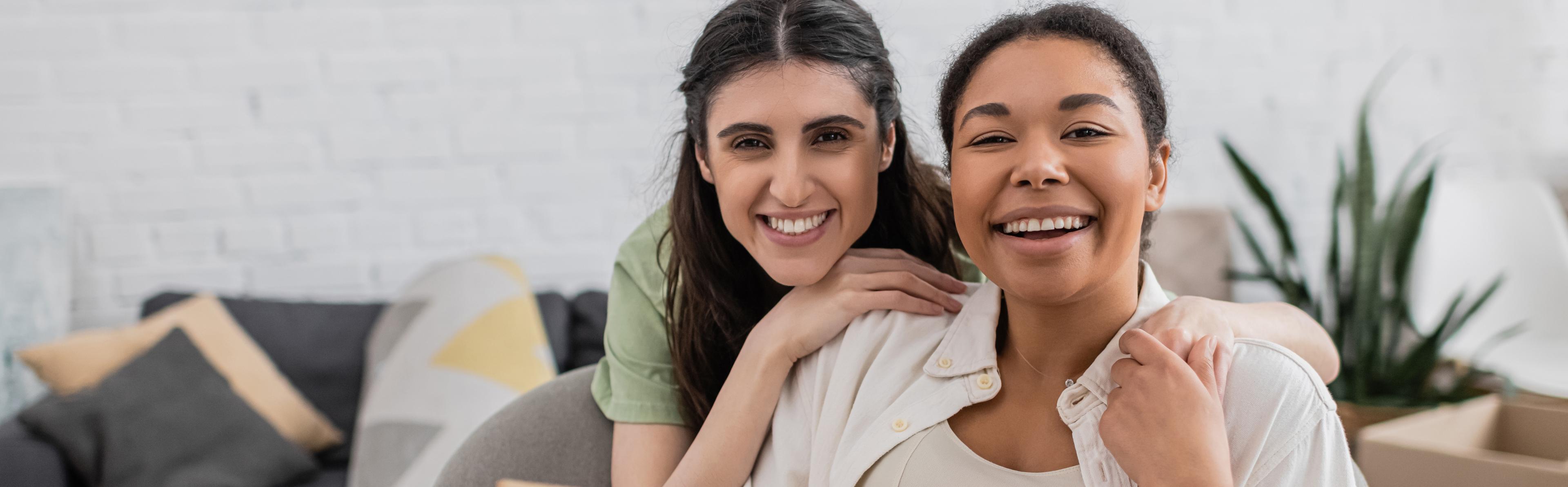 Two women holding hands and smiling