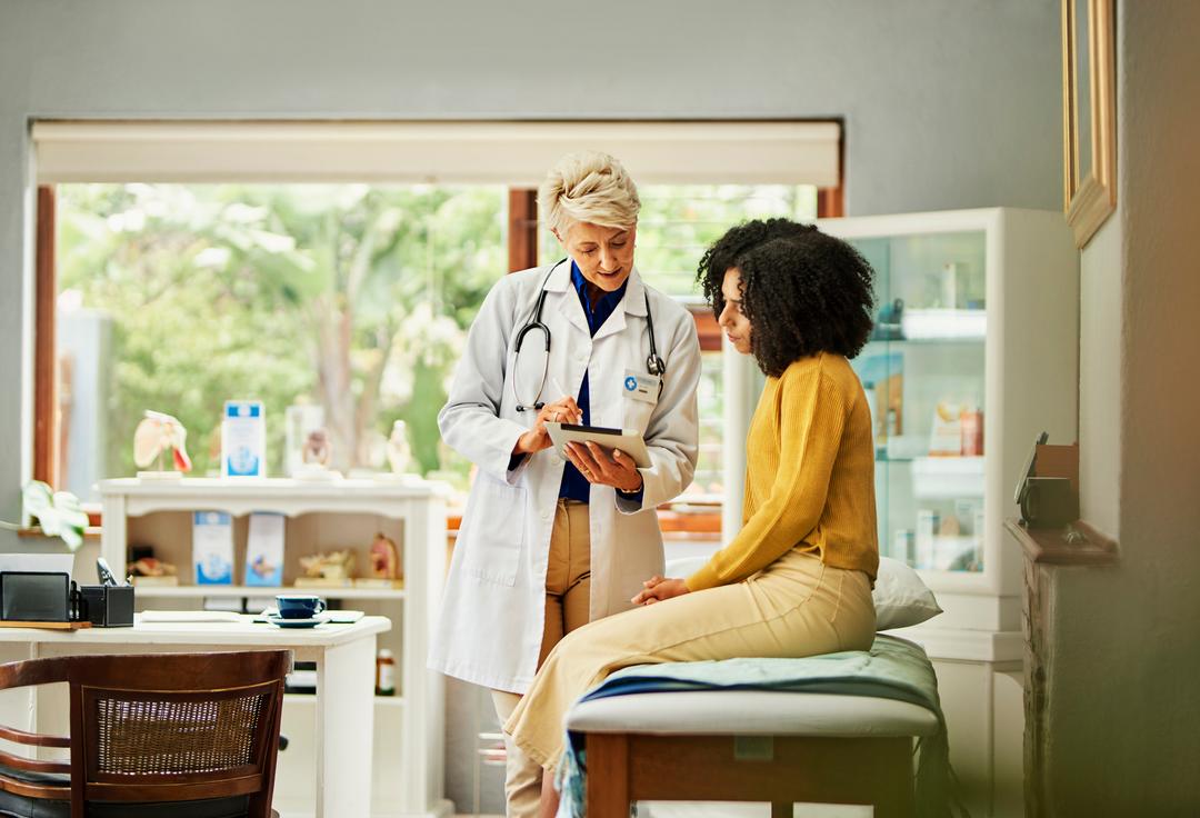 Doctor and patient looking at test results on digital tablet