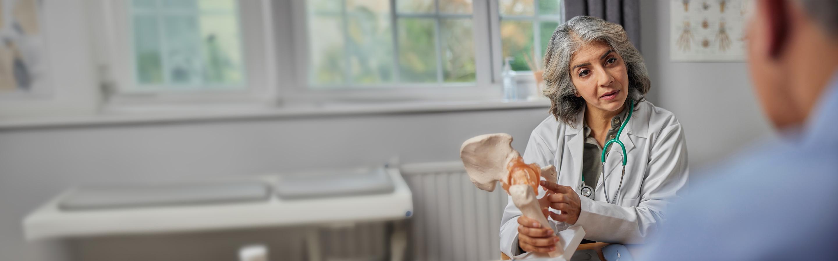 Doctor discusses a hip replacement with a patient
