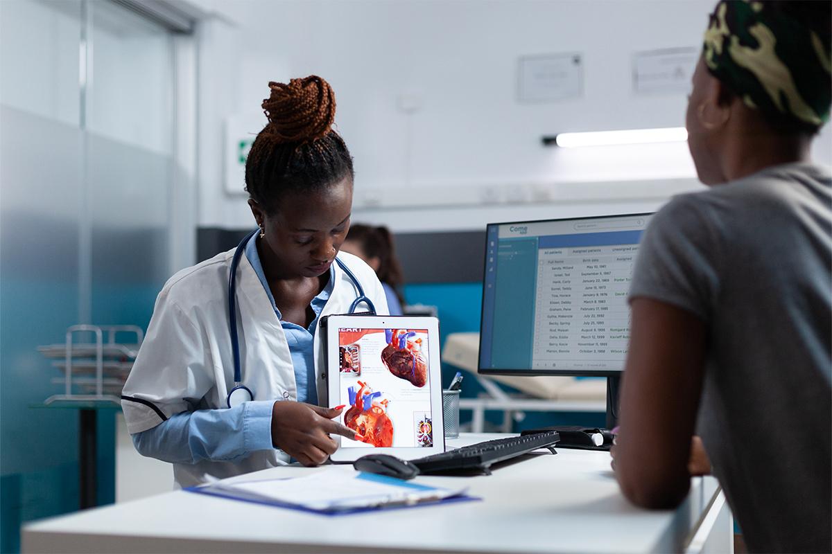 Doctor reviewing a heart diagram with a patient