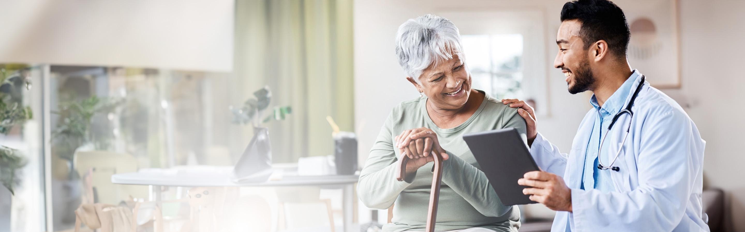 A caregiver reviews a chart with a female patient