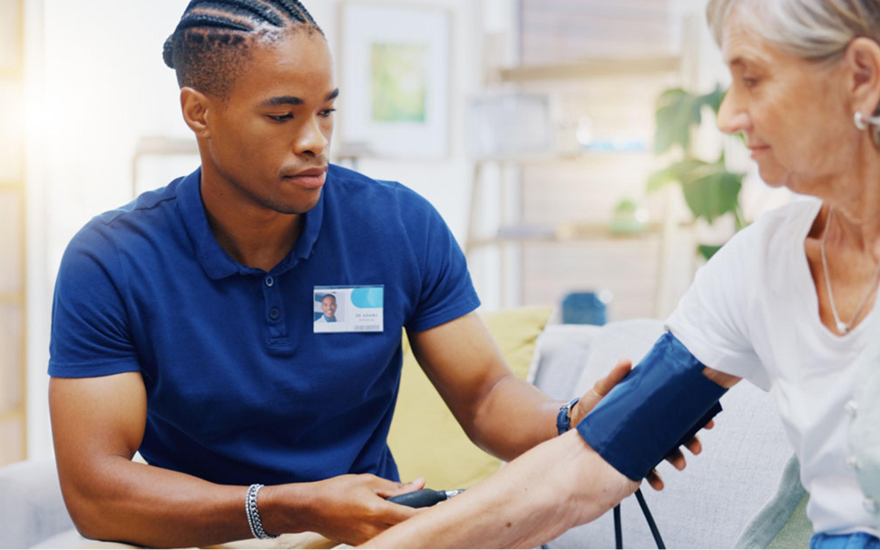 Nurse measuring blood pressure from elderly woman