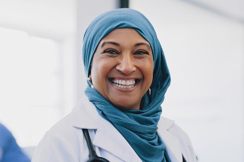 female doctor smiling and wearing a hijab