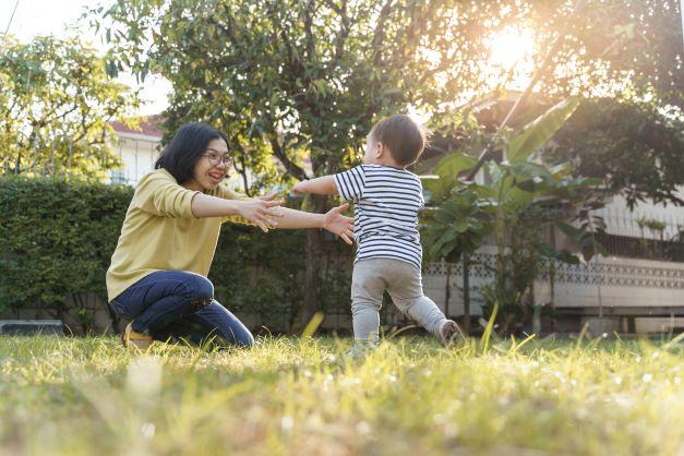 child running towards the arms of a woman