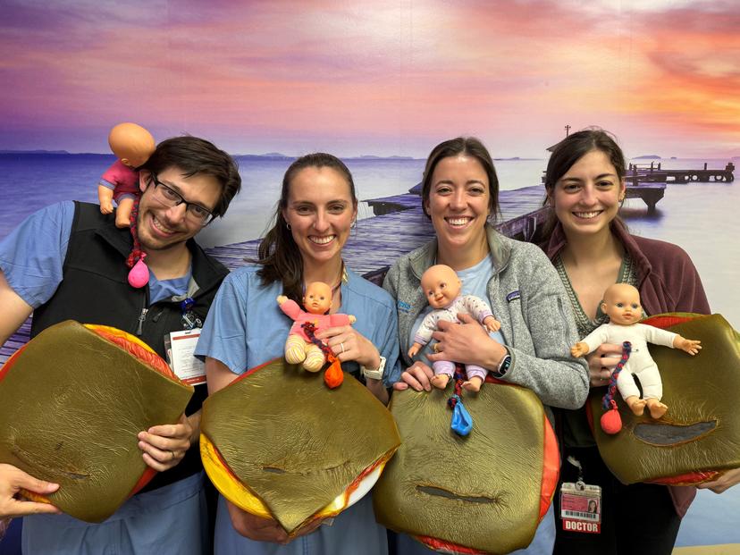 Saint Joseph Obstetric fellows holding fake babies