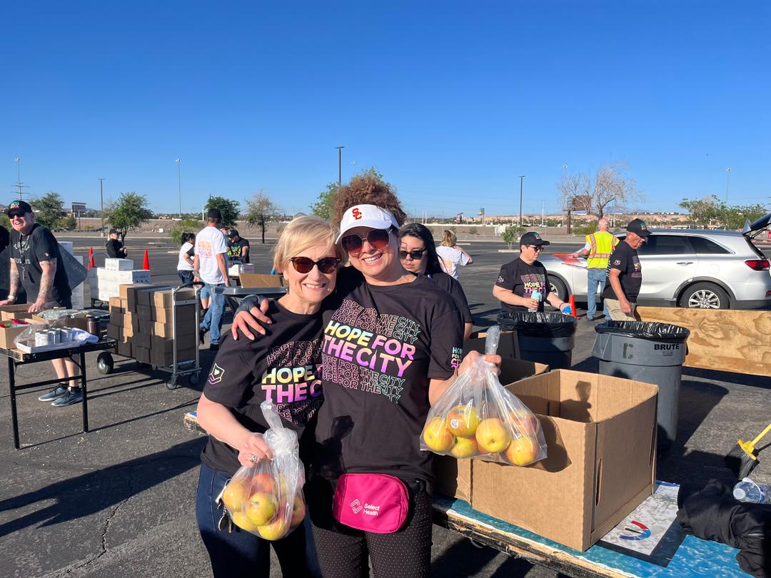 Women posing together at food hand out event