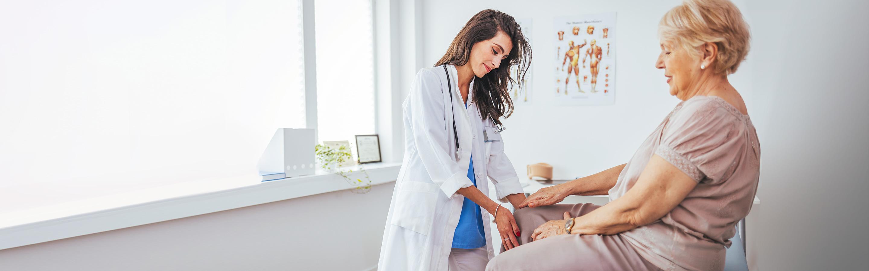Orthopedic joint specialist examines patient