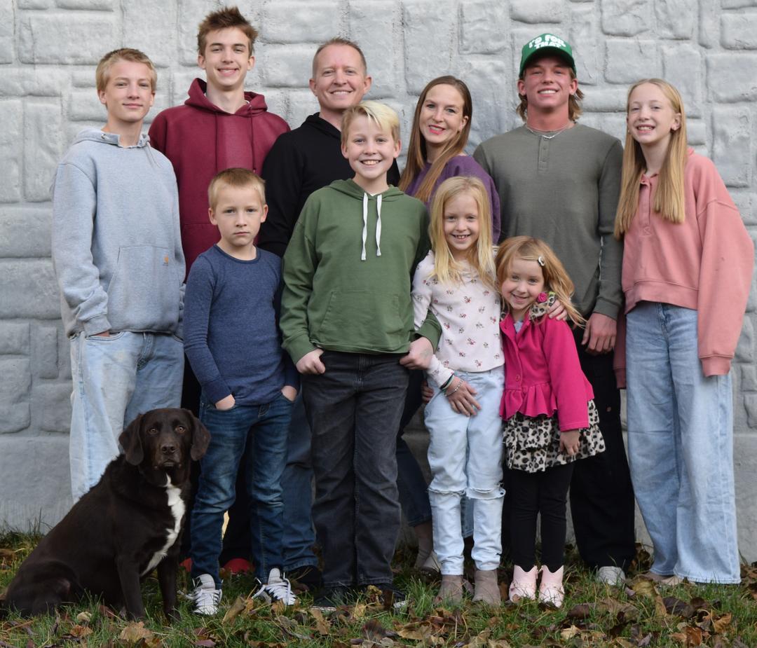 Family photo of people smiling at the camera