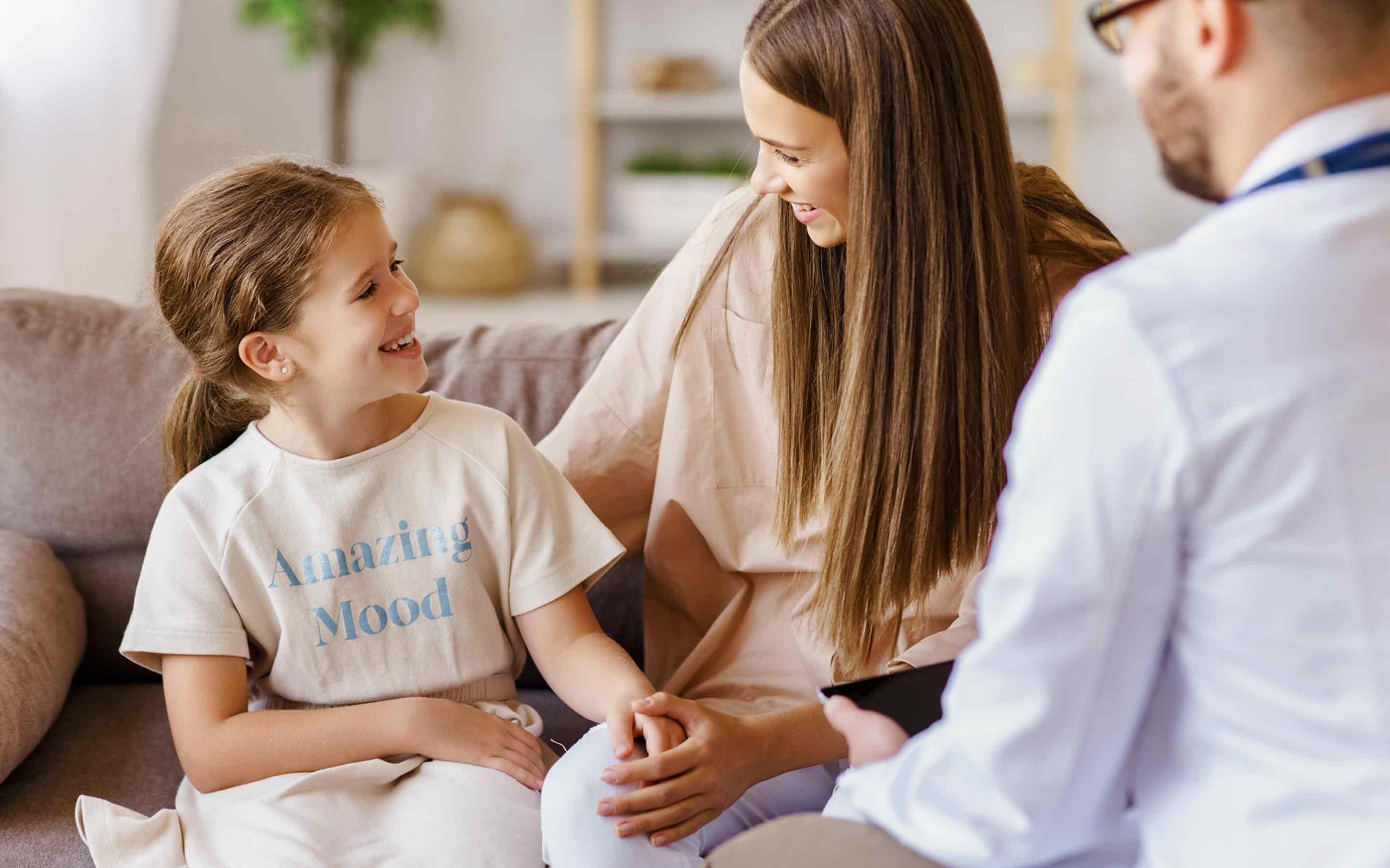 mom and daughter with family doctor