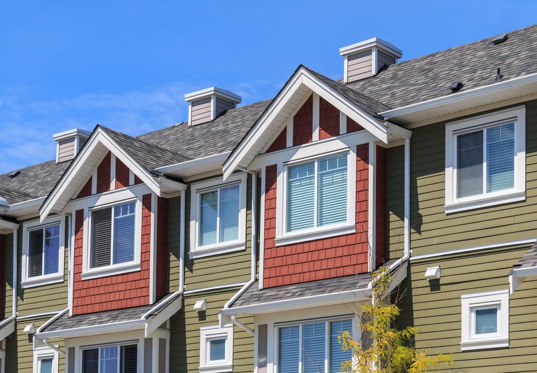 Duplex homes with orange and green facades