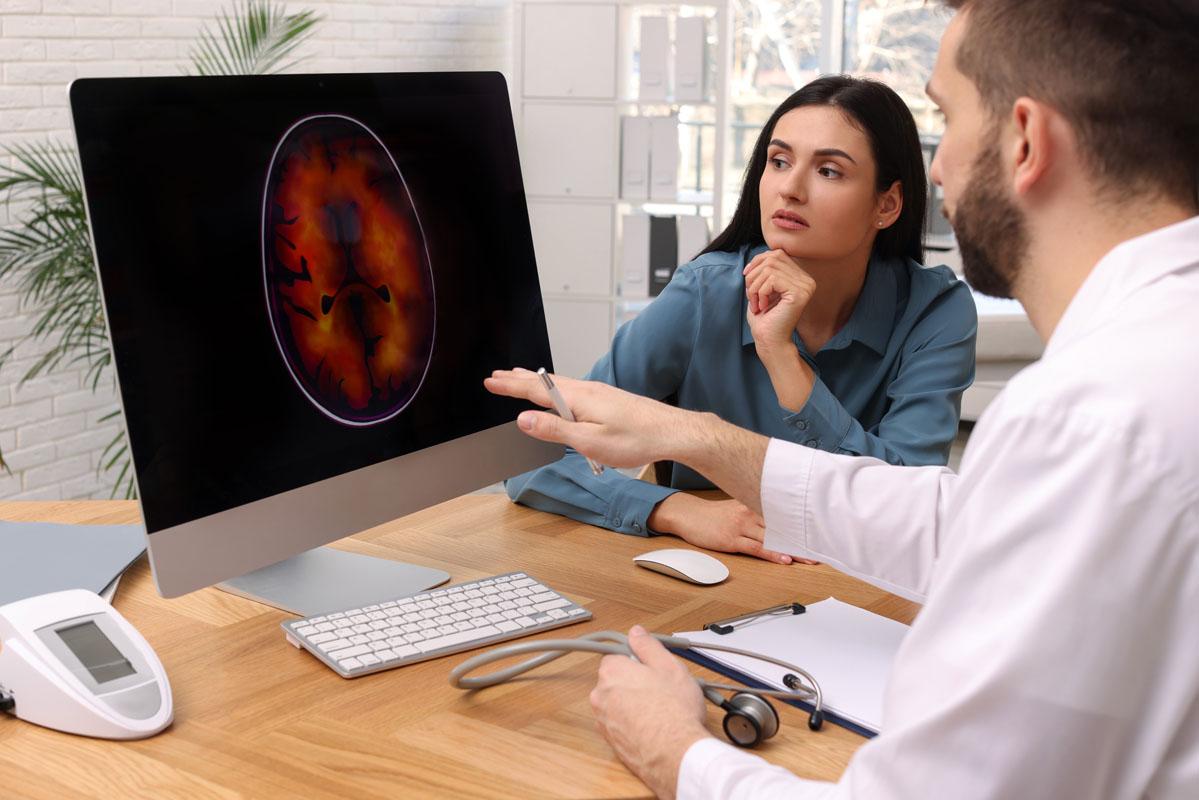 Reviewing brain scan with patient
