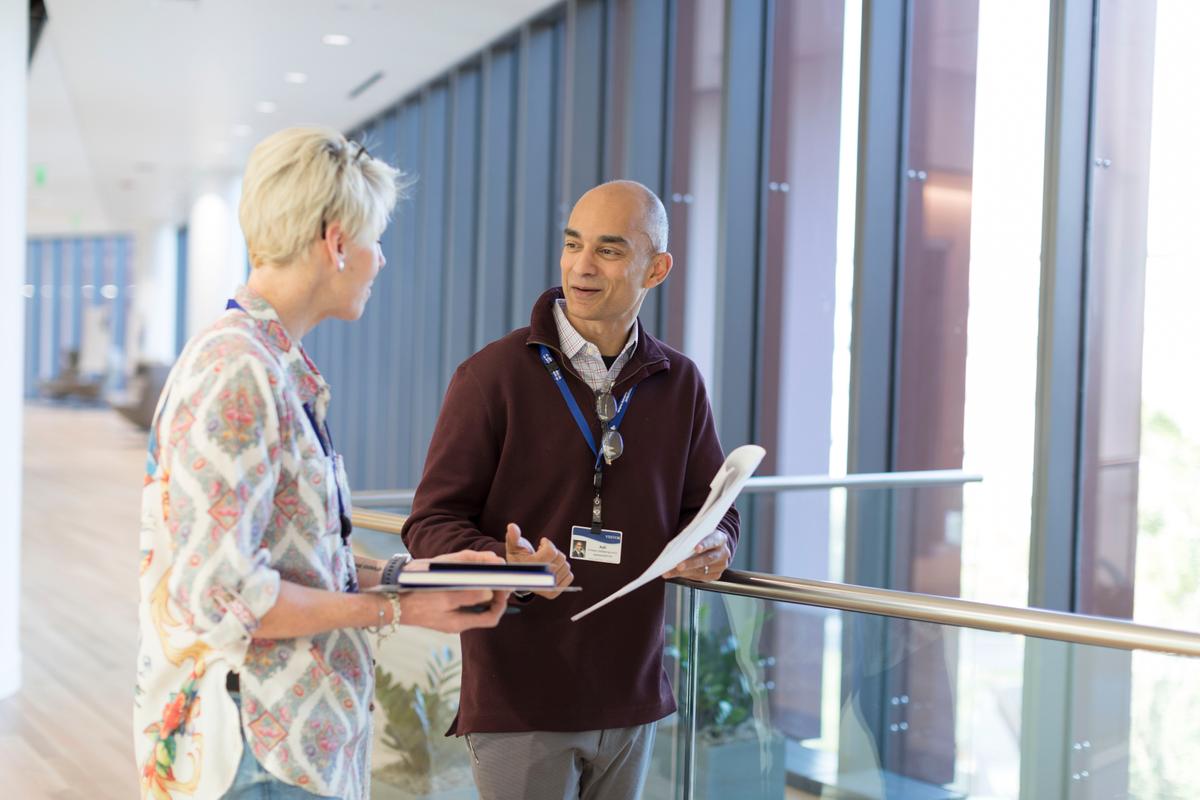 Two people having a discussion in a foyer