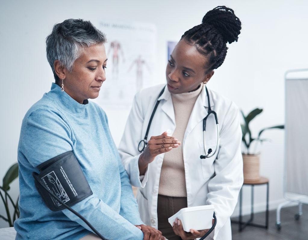 Patient getting blood pressure checked by medical professional