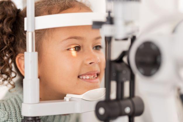 little girl getting her eyes checked at the eye doctor
