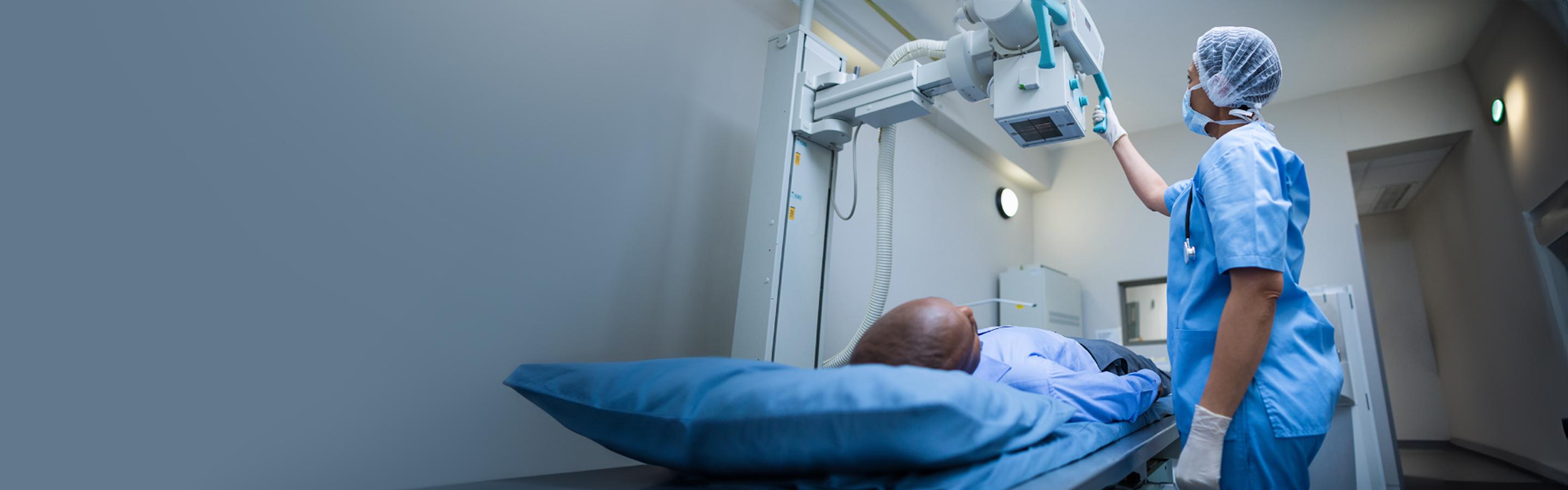 Technician setting up x-ray machine for a patient