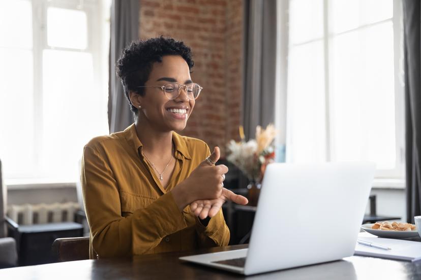 woman on a virtual meeting using sign language