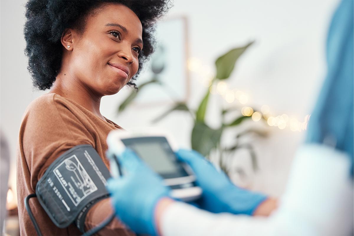 Young woman having her blood pressure taken