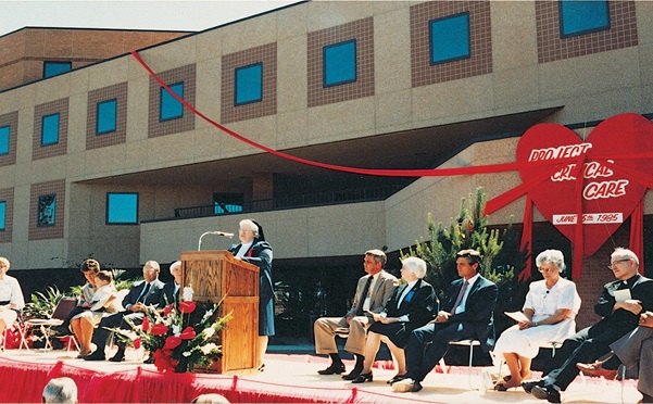 Front of SCL health building with a ceremony happening