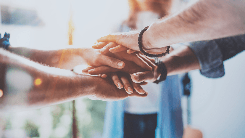 Group putting hands in center