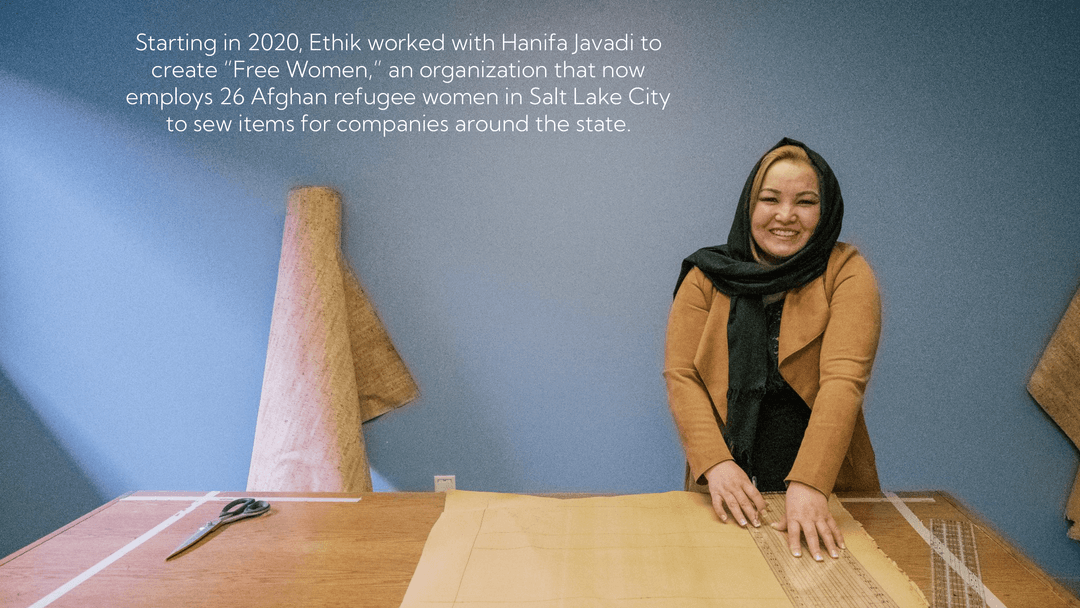 Smiling woman in a hijab measuring something on a wooden table